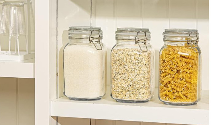 Clamp lid jars holding dry foods on pantry shelf