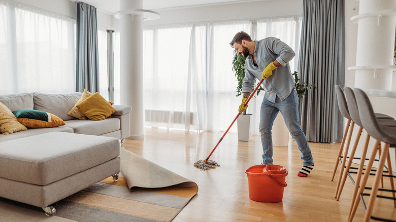 man cleaning apartment