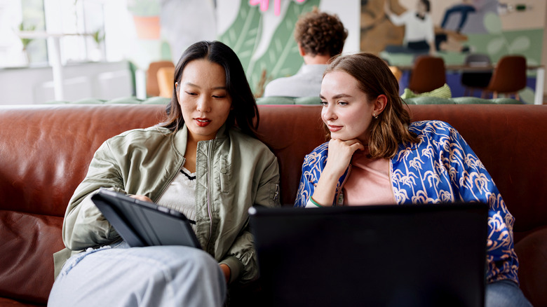 two women looking at computer