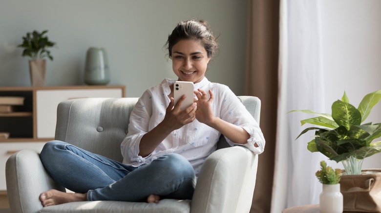 woman smiling at phone