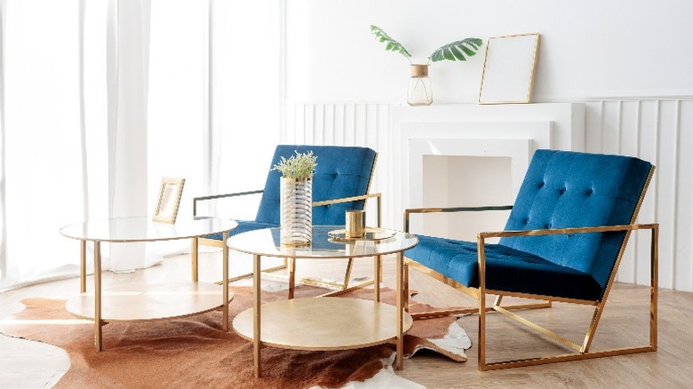 two blue chairs with gold legs