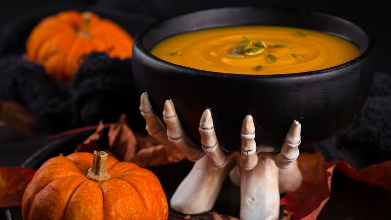 skeleton hand bowl with pumpkin