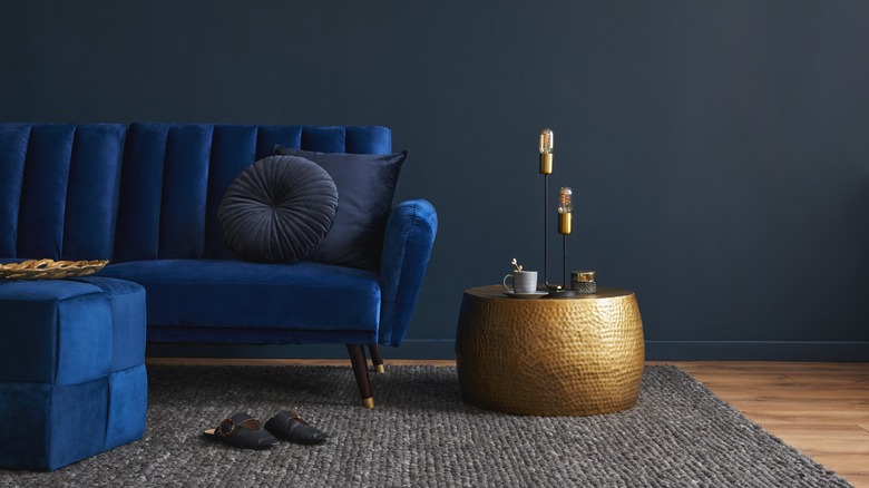 blue velvet couch and bronze accents