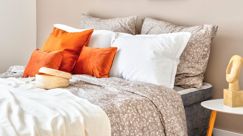 orange pillow shams with bed