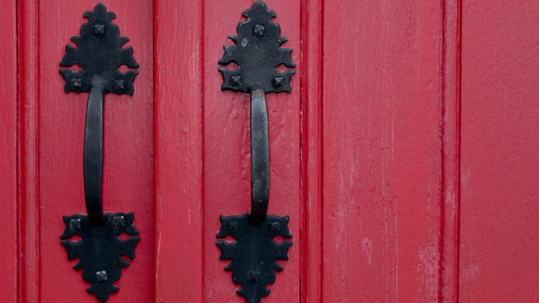 iron handles on red door