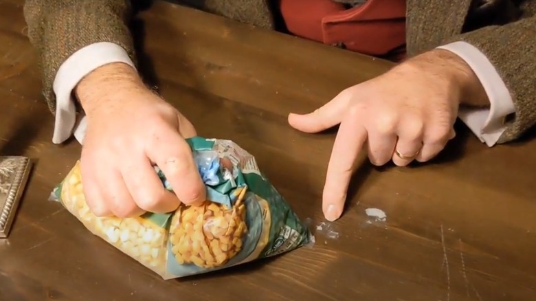 Holding frozen corn on table