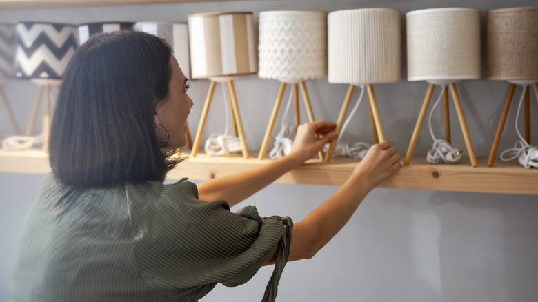 A person shopping for lamps.