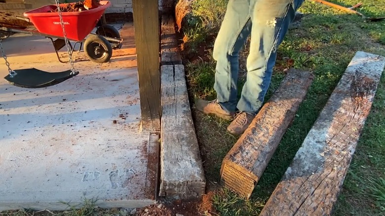 laying first row of railroad tiles for retaining wall