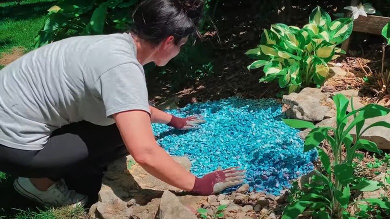 woman spreading gravel with rock glue on gravel