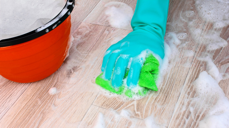 scrubbing floor with soapy water