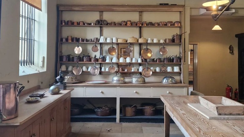 Historical kitchen with pots on shelves