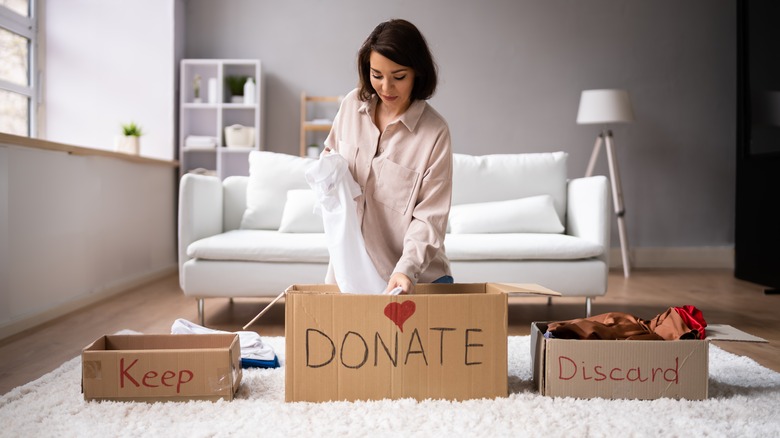 woman sorting clothes into boxes