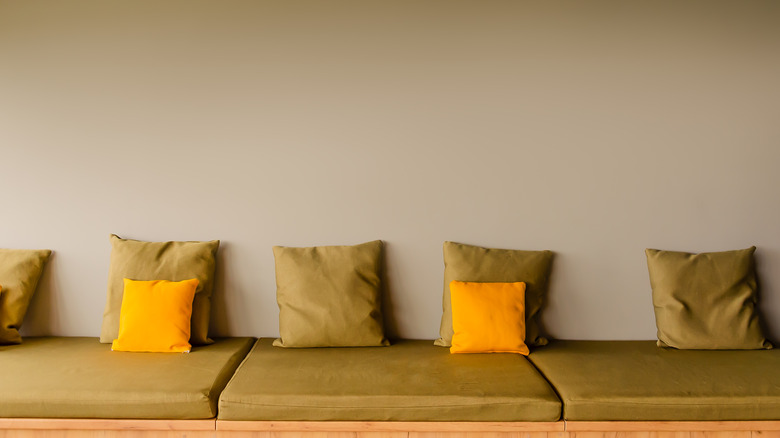 Khaki sofa with yellow pillows