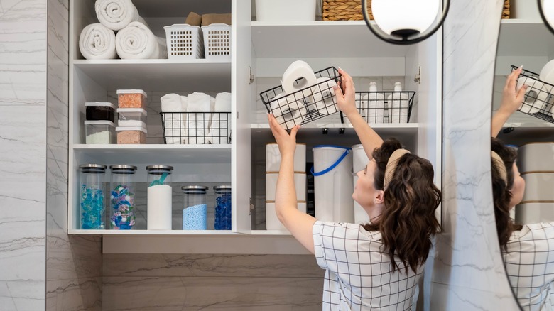 Woman organizing uneven shelves