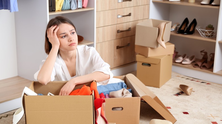 Person looking frustrated, disorganized room