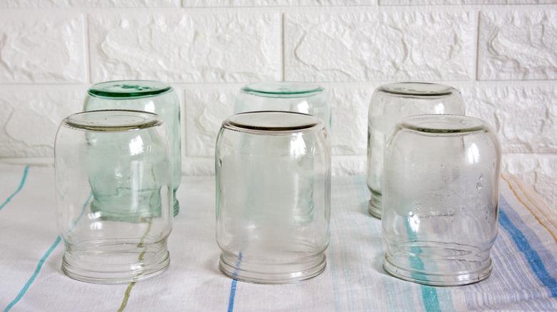 Clean, washed glass jars drying on a dishtowel