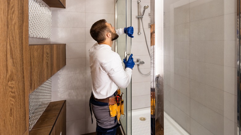 man installing shower door