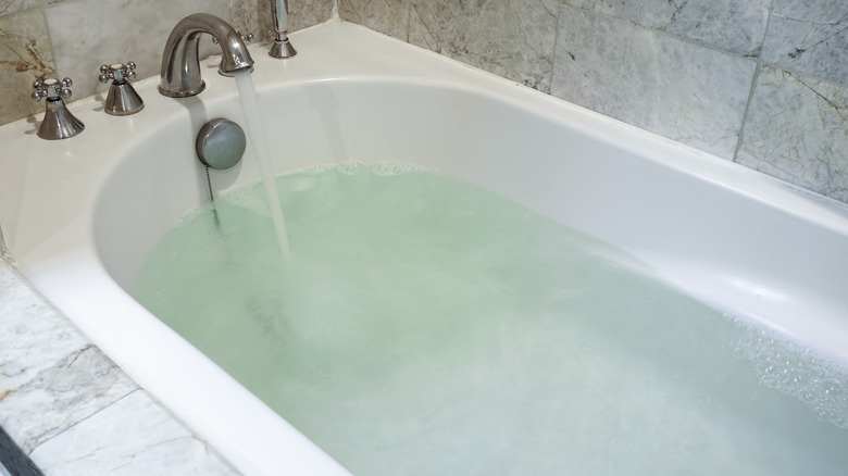 Bathtub with faucet running