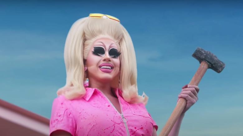 Trixie Motel holding a hammer