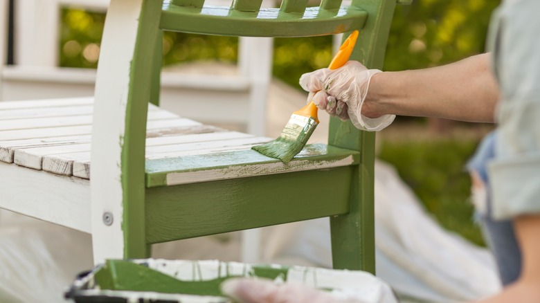 Painting wooden chair outdoors