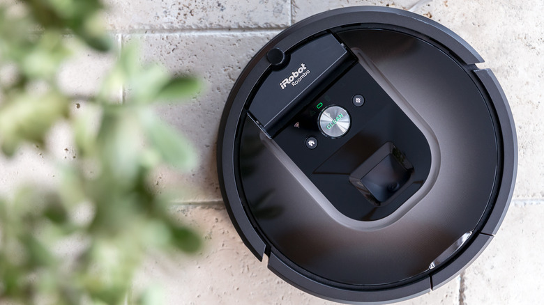 A Roomba on a tile floor