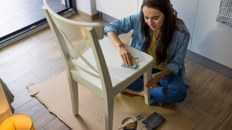 women refurbishing wooden chair