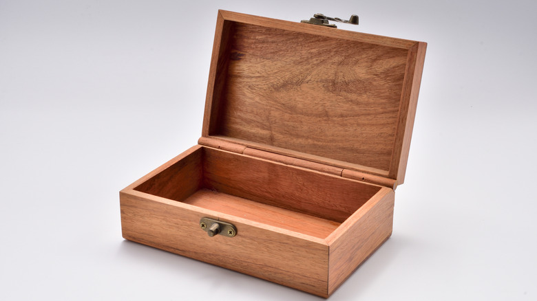 A wood lock box rests on a gray surface