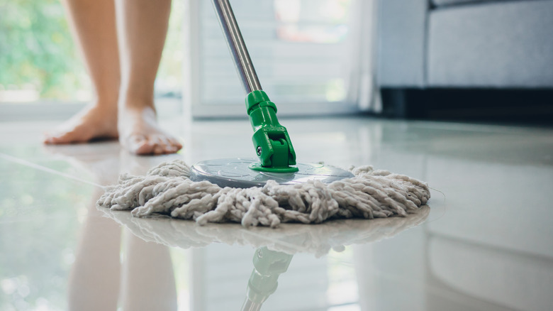 person mopping a floor