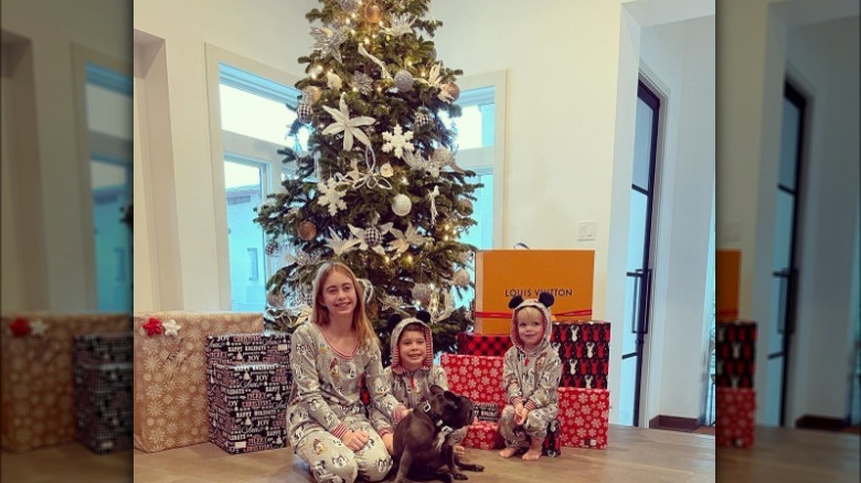 Christina Hall's children and dog in front of Christmas tree