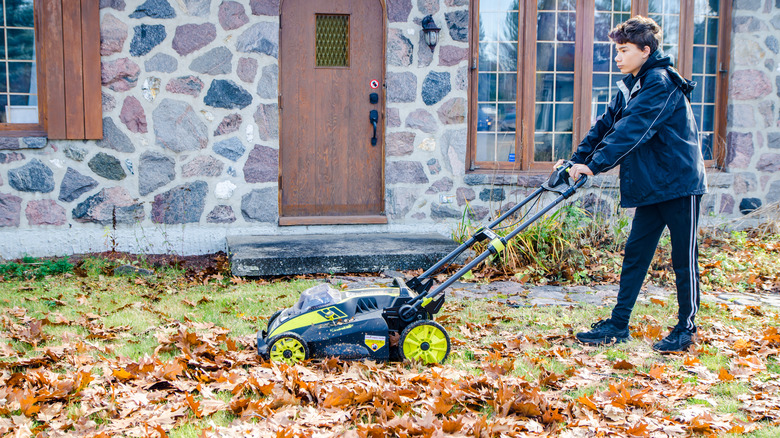 teen mowing leaves