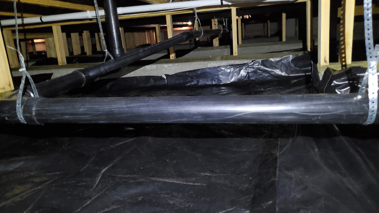 Black fabric laid in crawl space