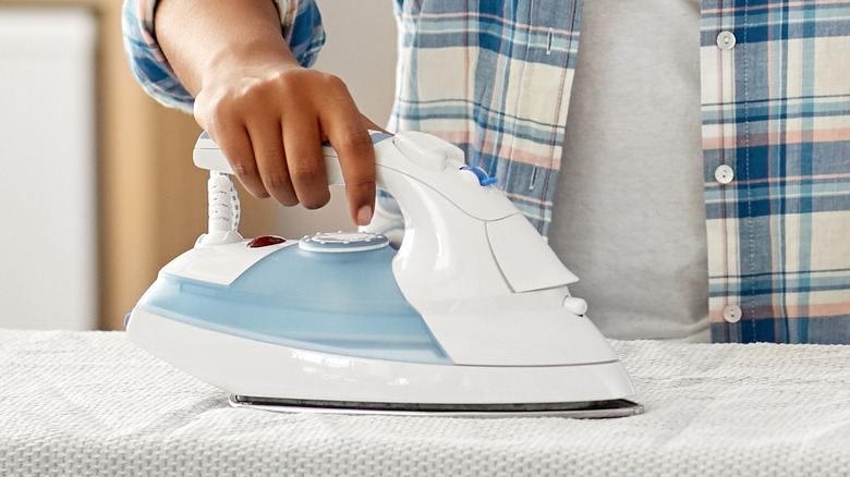 Person holding clothes iron