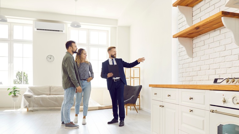 realtor showing couple around