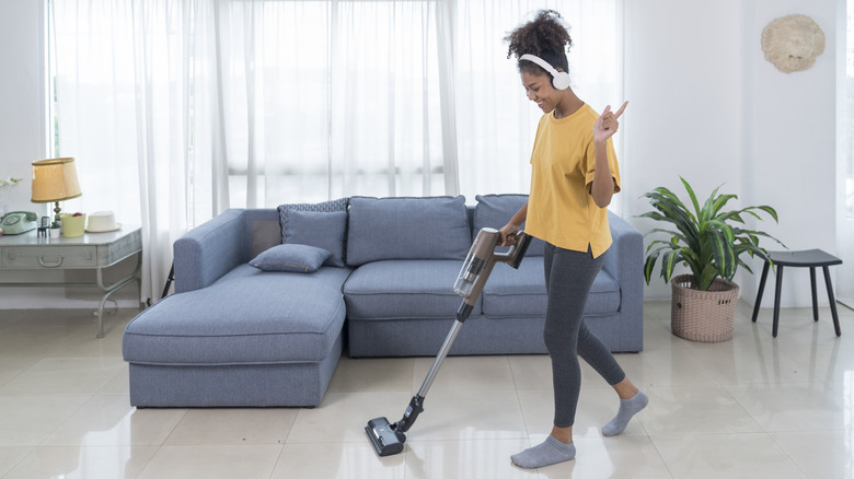 woman vacuuming minimalist home