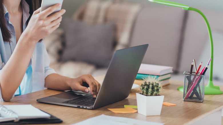 woman with phone in office