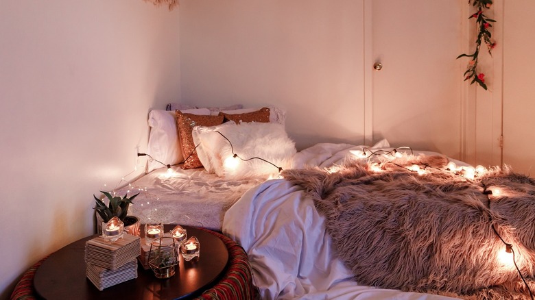 cozy scandinavian bedroom with string lights
