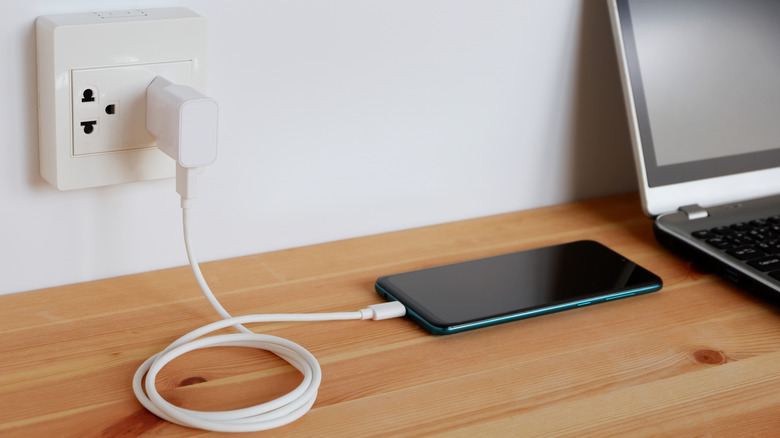 phone charging on side table