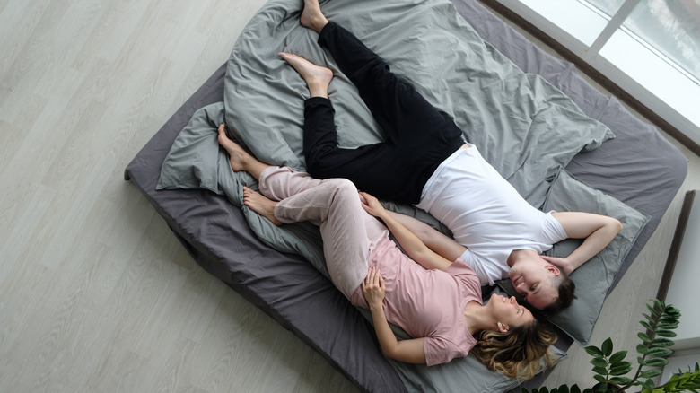 couple on mattress on floor