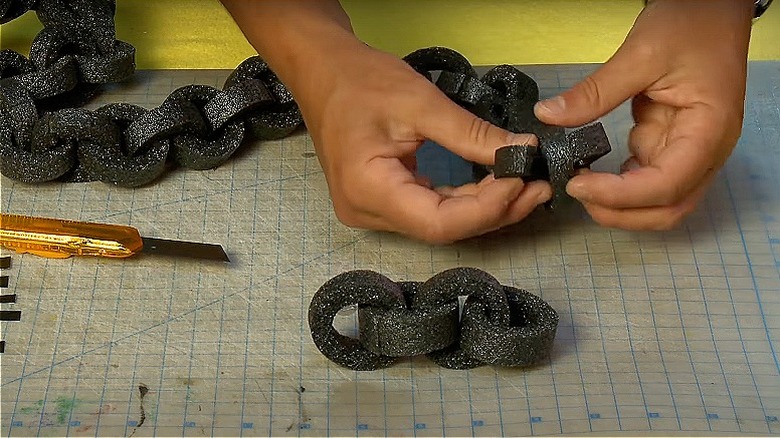 Woman making pool noodle chain 