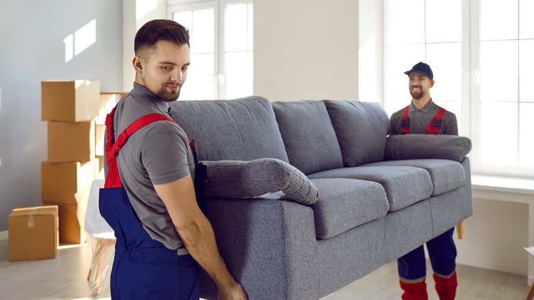 two men moving couch