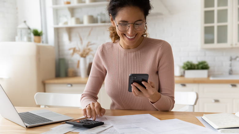 woman smiling at bills