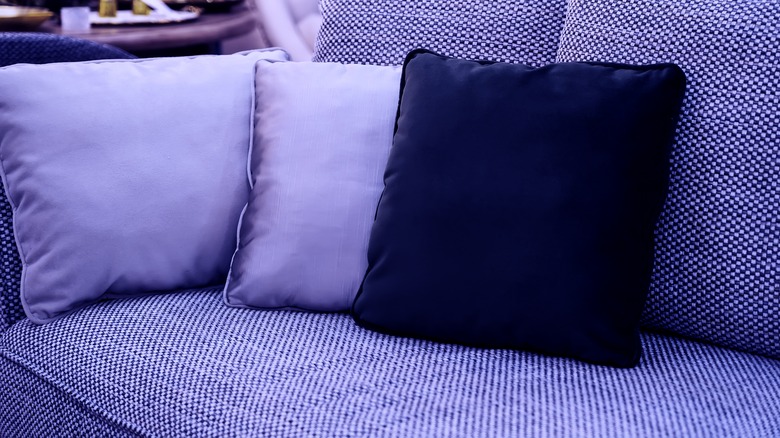 purple couch with pillows