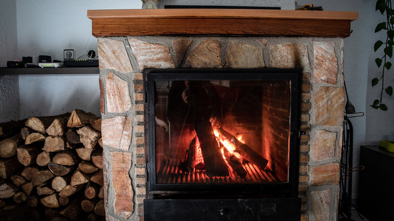 fireplace with stacked wood