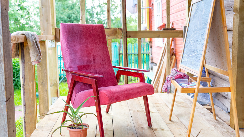 pink chair on wood porch