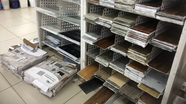 Packs of peel-and-stick vinyl floor tiles for sale in a hardware store.