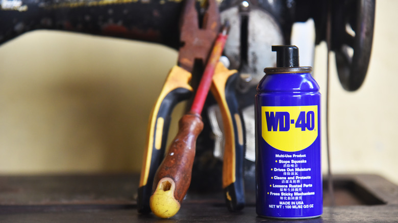 Can of WD-40 next to tools