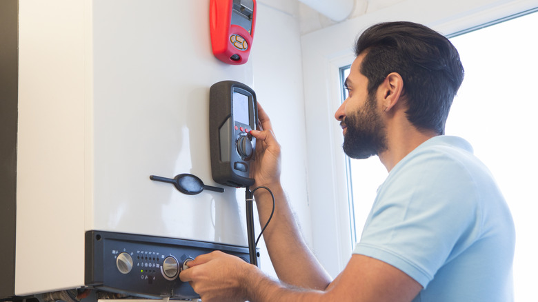 Man servicing a water heater