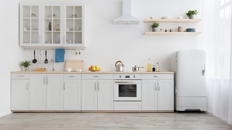 modern white kitchen with gray floor tiles