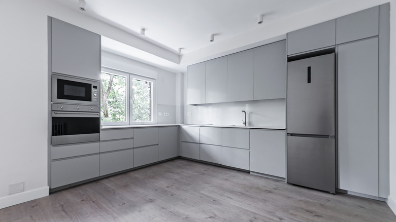 corner kitchen with pearl gray cabinets and gray floors