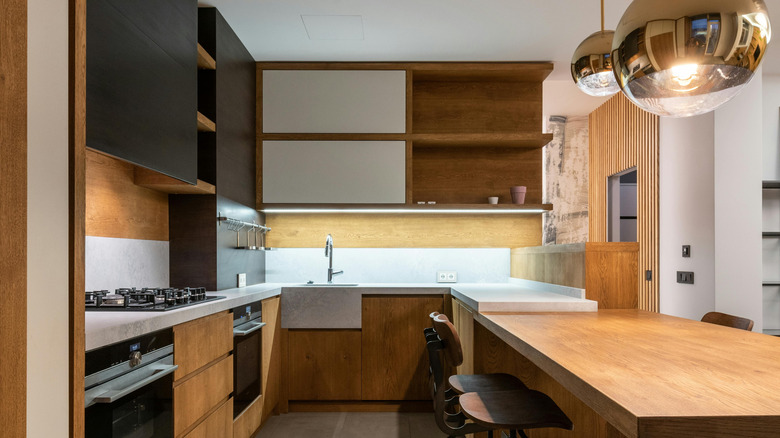 natural wood stained cabinets with gray floors